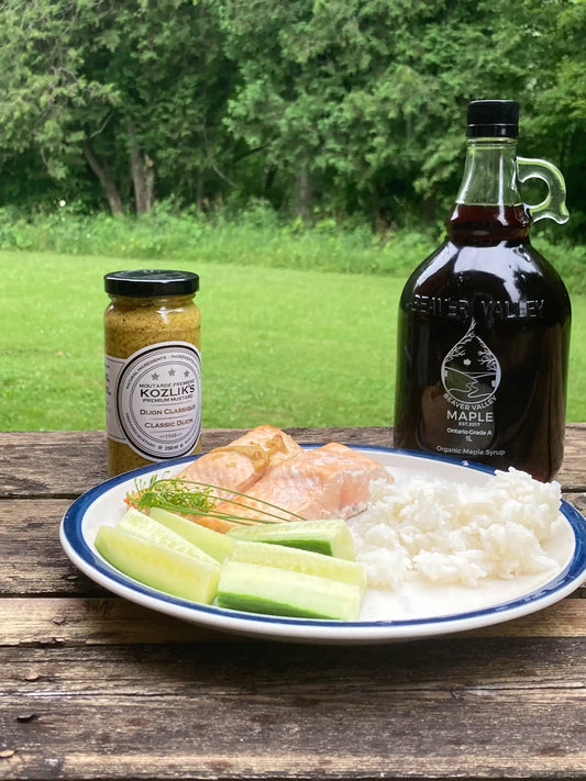 Maple glazed salmon with Kozlik's Dijon mustard and Beaver Valley Maple Syrup on a rustic outdoor table